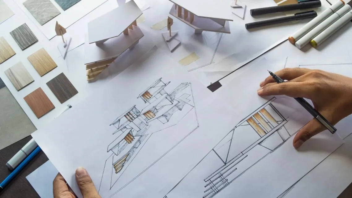 Designing Your First Room? Here Is How AI Floor Plan Makes It Way Less Stressful 13 Architect reviewing construction plans and blueprints.